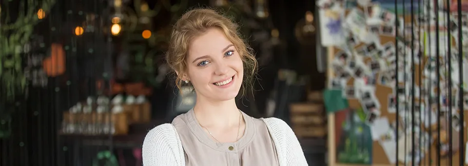 smiling woman working at her cafe